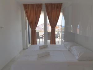 a white bed with two pillows on top of it at Villa Sunny Day Sendi Deluxe - Novalja in Novalja +27 photos