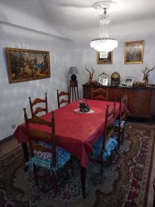 a dining room with a red table and chairs at Casa Ereño in Medina de Pomar