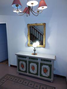 a dressing table with a mirror and a lamp on it at Casa Ereño in Medina de Pomar