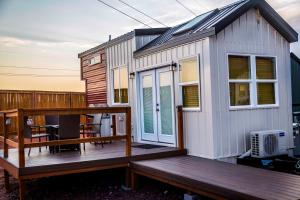 a tiny house on a deck with a balcony at Sun Catcher in Apple Valley