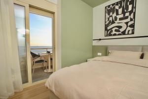 a bedroom with a bed and a view of the ocean at Luxurious Cozy seaview apartment in Durrës