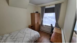 a bedroom with a bed and a large window at Happy House in Wyken