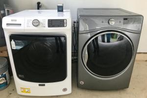 a microwave and a washing machine sitting next to each other at Hillcrest Hideaway in Eureka