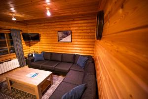 a living room with a couch and a table at Brimnes Bungalows in Ólafsfjörður