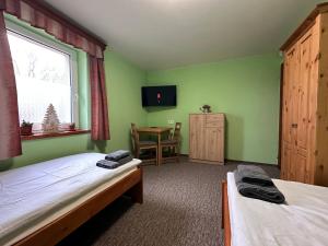 A bed or beds in a room at Ubytování Smrk