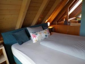 a bed with two pillows on it in a attic at Mondfänger Ferienwohnung , Nähe Playmobil Funpark und Messezentrum in Wilhermsdorf