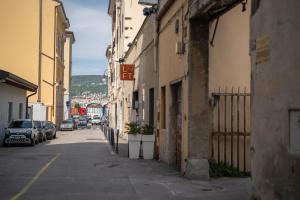 un callejón con coches estacionados en el lateral de un edificio en Elegante appartamento in Marina, en Trieste