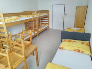 a dorm room with bunk beds and a couch at Penzion U Lipna in Přední Výtoň