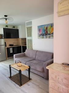 a living room with a couch and a table at Tahiti Beach in Frontignan