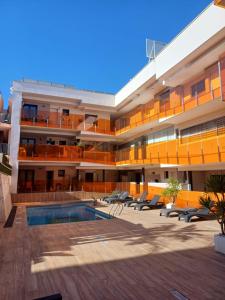 an exterior view of a building with a swimming pool at Умные новые аппартаменты в Торревьехе in Torrevieja