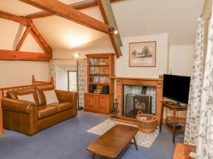 a living room with a couch and a fireplace at Gateside in Pickering