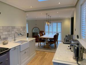 a kitchen with a table and a dining room at Stormfront Luxury Hideaway Glencoe Ballachulish Highlands Near Fortwilliam in Glencoe