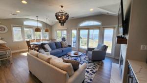 a living room with a couch and chairs and a table at No Fee Luxury Pet Friendly 7BR Soundfront retreat with Elevator, Heated Pool and Hot Tub in Kitty Hawk
