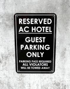 a sign that reads guest parking only parking pass required at AC Hotel By Marriott Salt Lake City Downtown in Salt Lake City