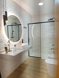 a bathroom with a sink and a mirror at APARTAMENTOS SAN NICOLAS in Adra