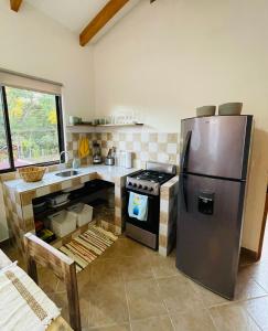 a kitchen with a stainless steel refrigerator and a stove at TRANQUILA CASA DE PLAYA in Santa Cruz