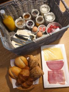a basket of bread and other food on a table at Erve iemhorst in Losser