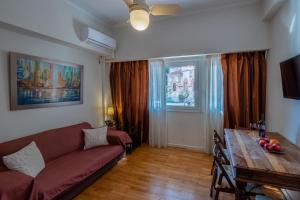 a living room with a couch and a table at Oro's Stylish Kolonaki Flats Next to Metro & Museums in Athens