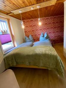 um quarto com uma cama com um edredão verde em Ferienhaus „Schlupfwinkel“, kostenloser Parkplatz, Vollausstattung em Ilmenau