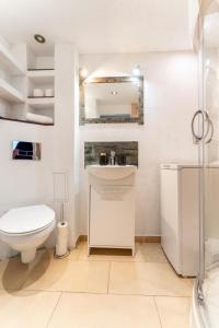a white bathroom with a toilet and a sink at Apartament Gold - 2 osobne sypialnie z balkonem - SpaceApart in Jelenia Góra