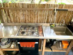 a kitchen with a sink and a stove at Casa Alma in Capurganá +29 photos