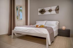 a bedroom with a bed with a tray of food on it at Villa Jacqueline con piscina privata 8 posti letto in Scopello +41 photos