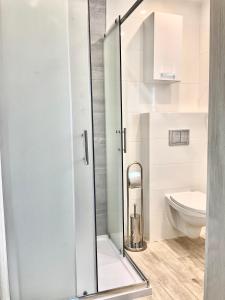 a bathroom with a shower and a toilet at Apartamenty u Lucyny i Lecha in Łukęcin +53 photos