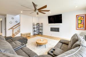 a living room with a couch and a ceiling fan at Lakefront Fredericksburg Home with Deck and Fire Pits! in Fredericksburg