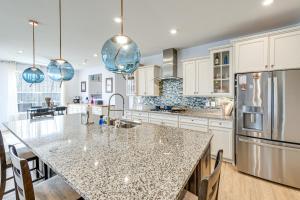 a kitchen with a large island with a counter top at Lakefront Fredericksburg Home with Deck and Fire Pits! in Fredericksburg