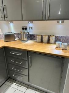 a kitchen with a counter top with cups on it at Luxury Manchester Arena Apartment by Cloud Suites in Manchester