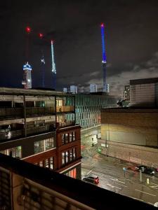 a view of a city at night with tall buildings at Luxury Manchester Arena Apartment by Cloud Suites in Manchester