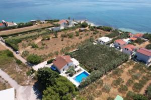 an aerial view of a house with a swimming pool at Villa Olive Tree in Kaštela