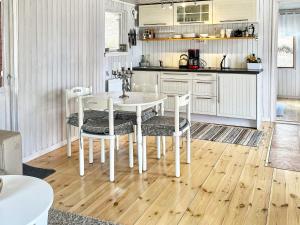 a kitchen with a white table and chairs at 8 person holiday home in FAGERHULT-By Traum in Fagerhult