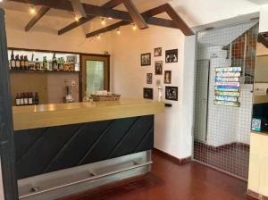 a bar in a bathroom with a shower at Hotel Sol y Sierras in La Falda