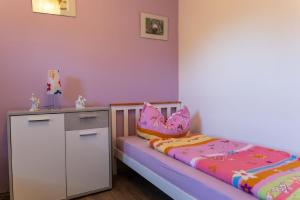 a childs bedroom with a bed and a cabinet at Ferienwohnung mit zwei Schlafzimmern und Balkon - b56485 in Weißenstadt
