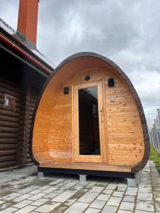 a circular building with a wooden door on a house at Dzikie Gąski in Gąski +3 photos