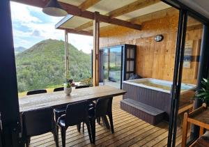 a room with a table and chairs and a tub at Cloud 9 Estate - Chalet in Knysna