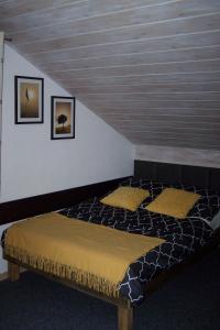 a bed with two pillows in a room at Pokoje Goscinne Na Skarpie in Jastrzębia Góra