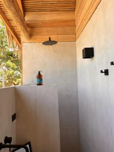 een fles bovenop een koelkast in een kamer bij Naturnahe Cabina Playa Hermosa, Santa Teresa in Santiago