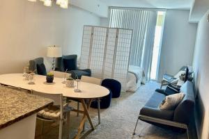 a room with a table and chairs and a bed at 314S Nautical Beach Suite - 2 Beds!, Pools, Jacuzzi, Beach, Shops & Dog Friendly in Boynton Beach