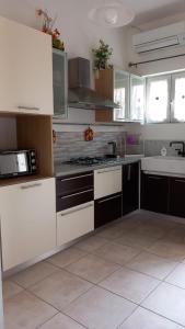 a kitchen with white cabinets and a stove top oven at Casa Bianca in Marina di Massa