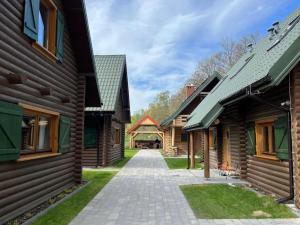 a walkway between two wooden buildings at Dzikie Gąski in Gąski