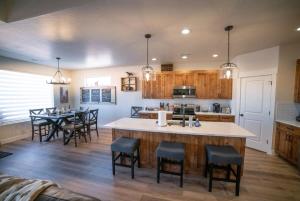 a kitchen and dining room with a large island in the middle at Red Canyon Bunkhouse at Kanab - New West Properties in Kanab