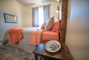 a bedroom with a bed and a table and a mirror at Red Canyon Bunkhouse at Kanab - New West Properties in Kanab