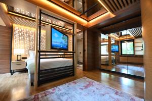 貝爾格勒的住宿－Hanami Design Hotel，一间卧室配有一张床和一台电视。
