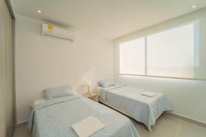 Postel nebo postele na pokoji v ubytování 1H Encanto Rentals @ Sunno Beach