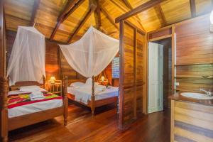 Postel nebo postele na pokoji v ubytování Ecolodges Karet