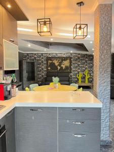 a kitchen with a counter and a table in it at Villa con Jacuzzi in Ponte Galeria