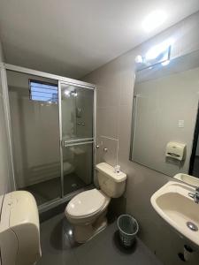 een badkamer met een toilet, een douche en een wastafel bij Hotel HSR in Panama-Stad