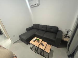 a living room with a couch and a coffee table at Kalofas Apartments Amaryllis in Ofrínion